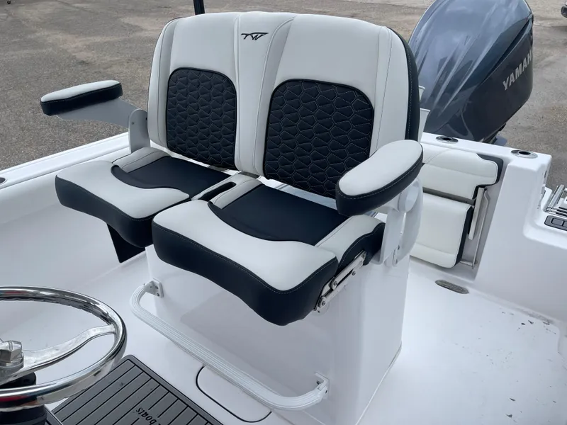 Slide: The Image of 2025 Tidewater 232cc boat seating with Yamaha engine, featuring stylish black and white upholstery. - 13