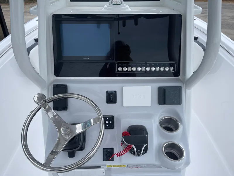 Slide: The Image of 2025 Tidewater 232cc boat console with steering wheel and electronic controls. - 15