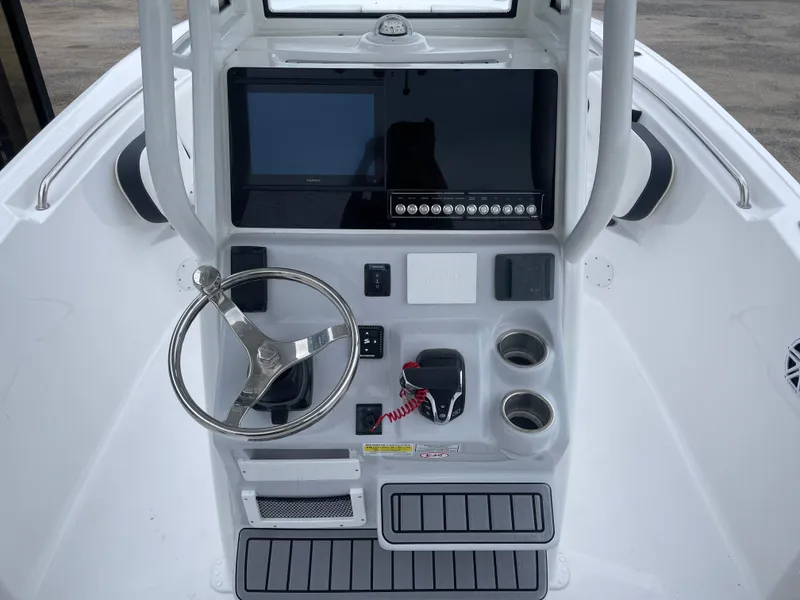 Slide: The Image of 2025 Tidewater 232cc boat console with steering wheel and electronic controls. - 16