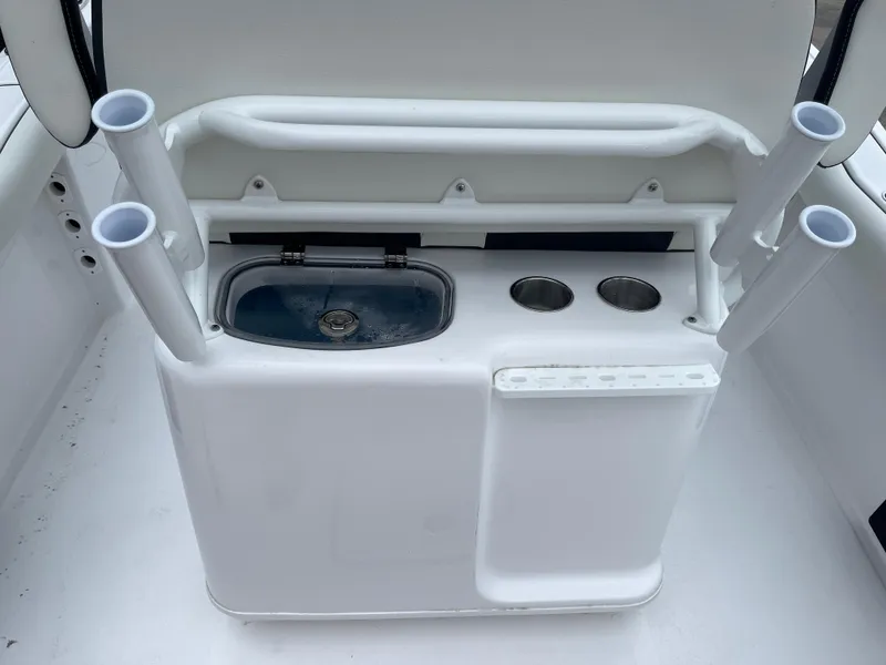 Slide: The Image of Tidewater 232cc 2025 boat console with rod holders and storage compartments. - 18