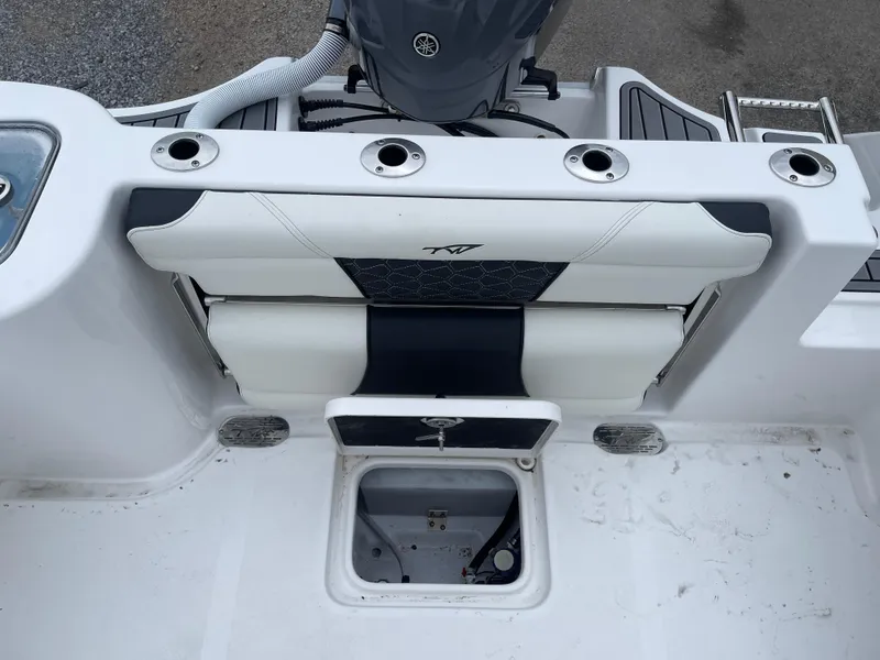 Slide: The Image of 2025 Tidewater 232cc boat interior with seating and storage compartment. - 19