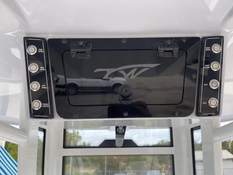 Slide: The Image of 2025 Tidewater 232cc boat control panel with various switches and logo. - 26