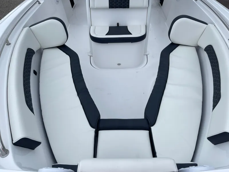 Slide: The Image of 2025 Tidewater 232cc boat interior with white and black cushioned seating. - 36