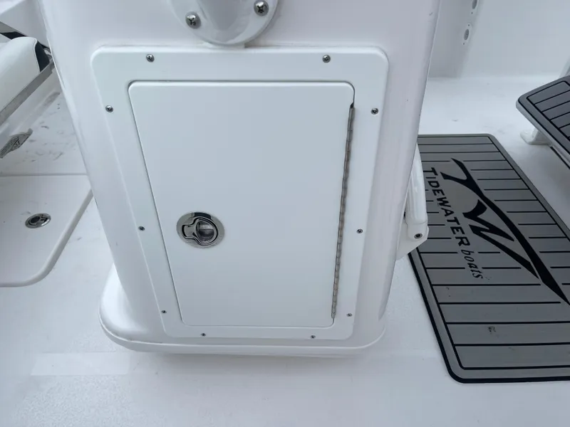 Slide: The Image of 2025 Tidewater 232cc boat console with storage compartment and branded mat. - 41