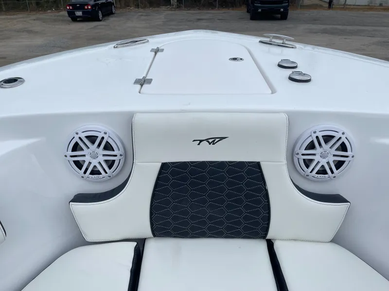 Slide: The Image of 2025 Tidewater 232cc boat interior with speakers and cushioned seating. - 44