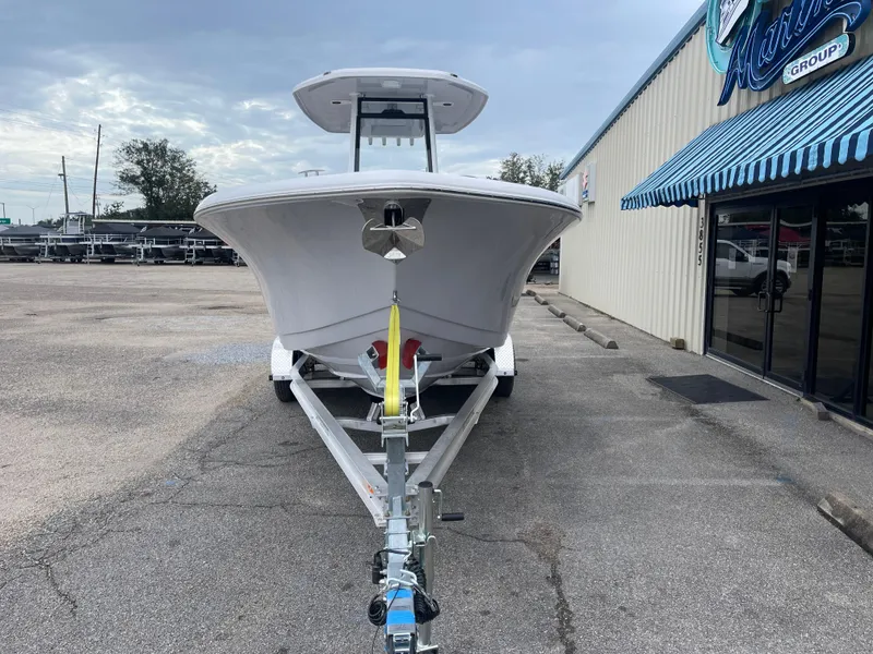 Slide: The Image of 2025 Tidewater 232cc boat on trailer outside marine dealership. - 5