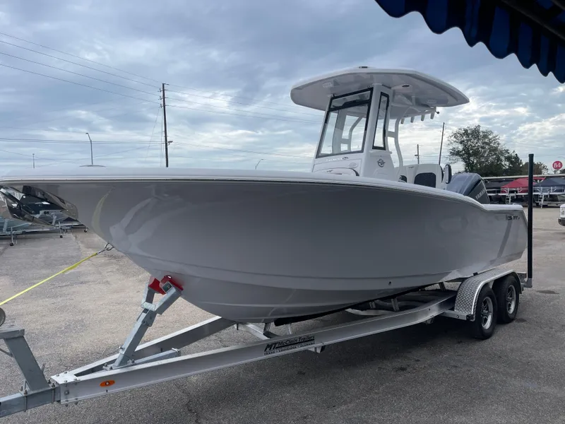 Slide: The Image of 2025 Tidewater 232cc boat on trailer under cloudy sky. - 7