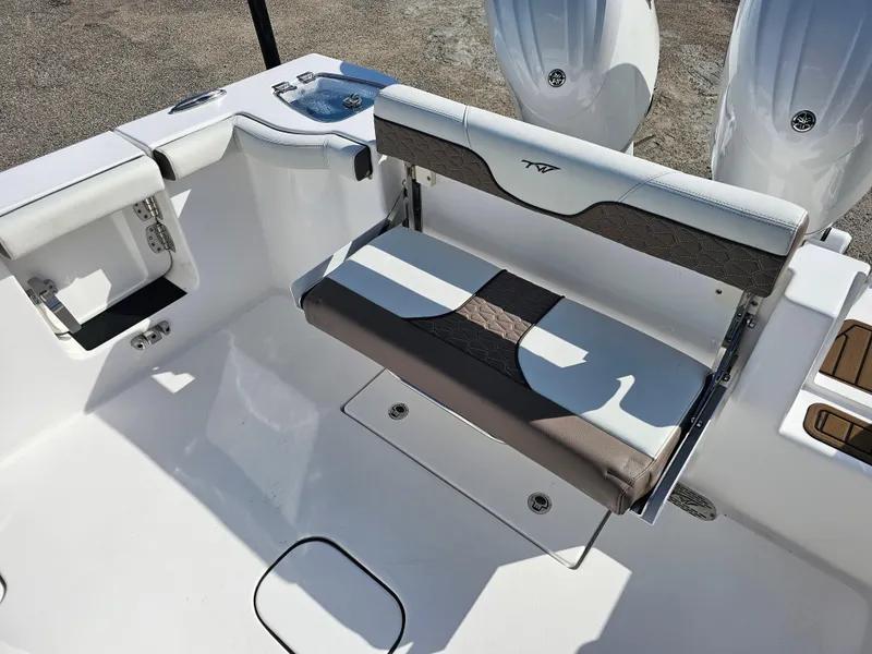 Slide: The Image of 2024 Tidewater 272cc boat interior with seating and dual engines. - 11