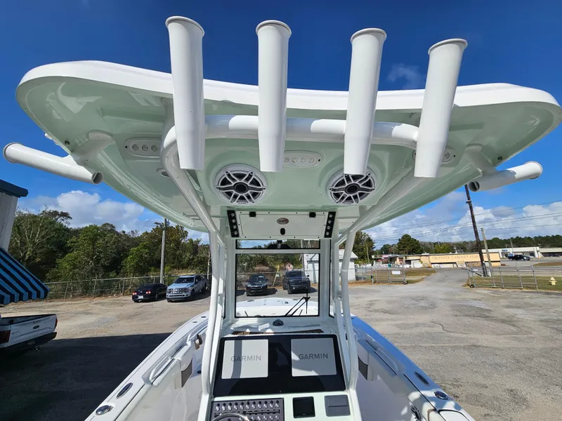 Slide: The Image of 2024 Tidewater 272cc boat with rod holders and Garmin electronics, parked outdoors. - 21