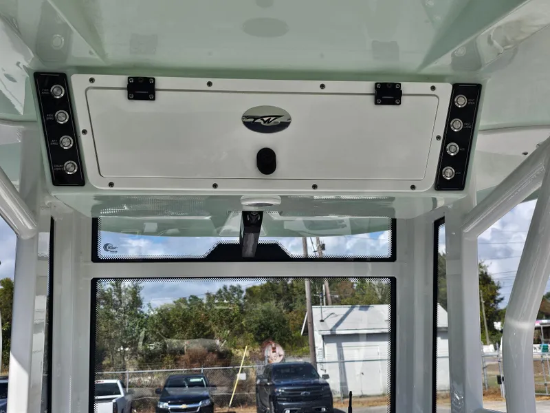 Slide: The Image of 2024 Tidewater 272cc boat interior with control panel and windshield view. - 22