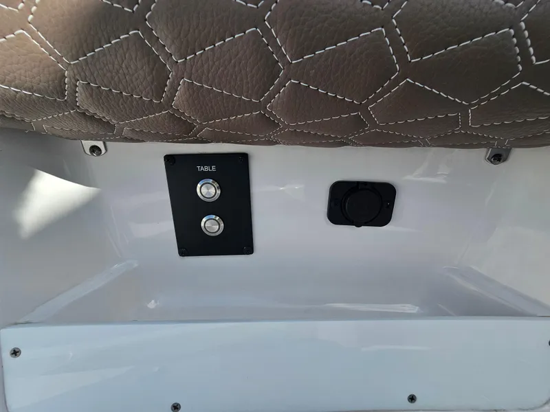 Slide: The Image of 2024 Tidewater 272cc boat interior with table controls and leather seating. - 27