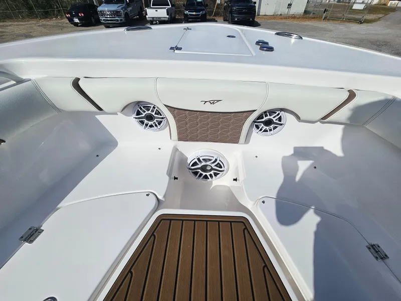 Slide: The Image of 2024 Tidewater 272cc boat interior with speakers and wood-style flooring. - 28