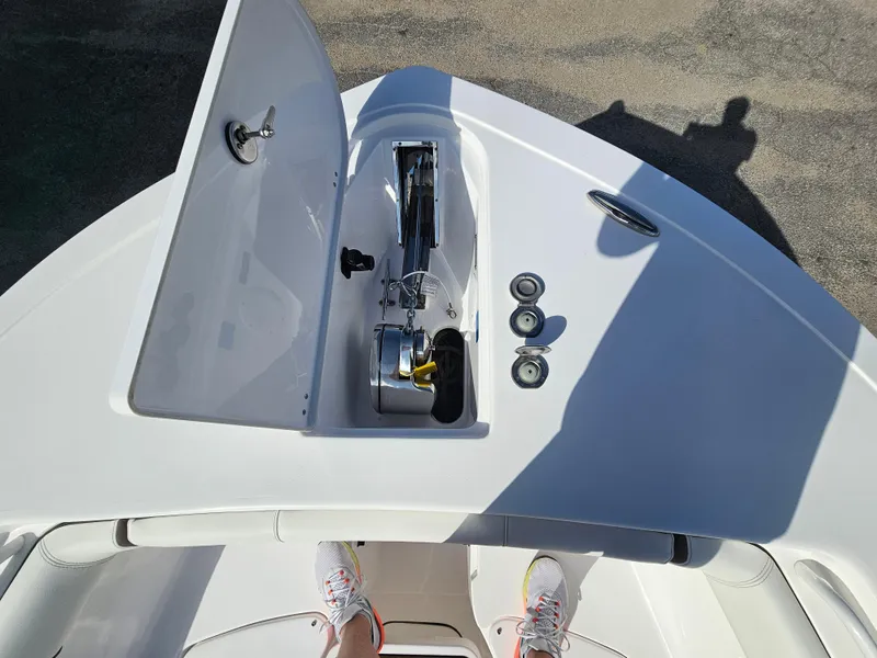 Slide: The Image of 2024 Tidewater 272cc boat deck with open storage compartment and visible anchor system. - 30