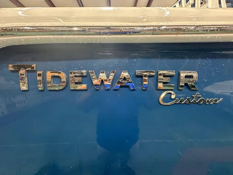 Slide: The Image of 2024 Tidewater 292CC boat logo on blue hull with water droplets. - 10