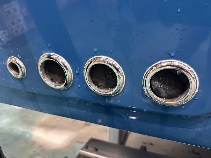 Slide: The Image of Close-up of 2024 Tidewater 292CC boat exhaust ports with chrome finish. - 11