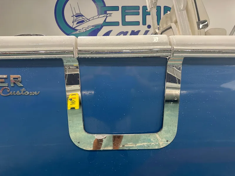 Slide: The Image of 2024 Tidewater 292CC boat with blue exterior and chrome accents. - 12