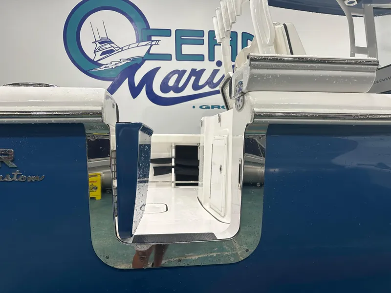 Slide: The Image of 2024 Tidewater 292CC boat with open side door, displayed at Ocean Marine. - 13