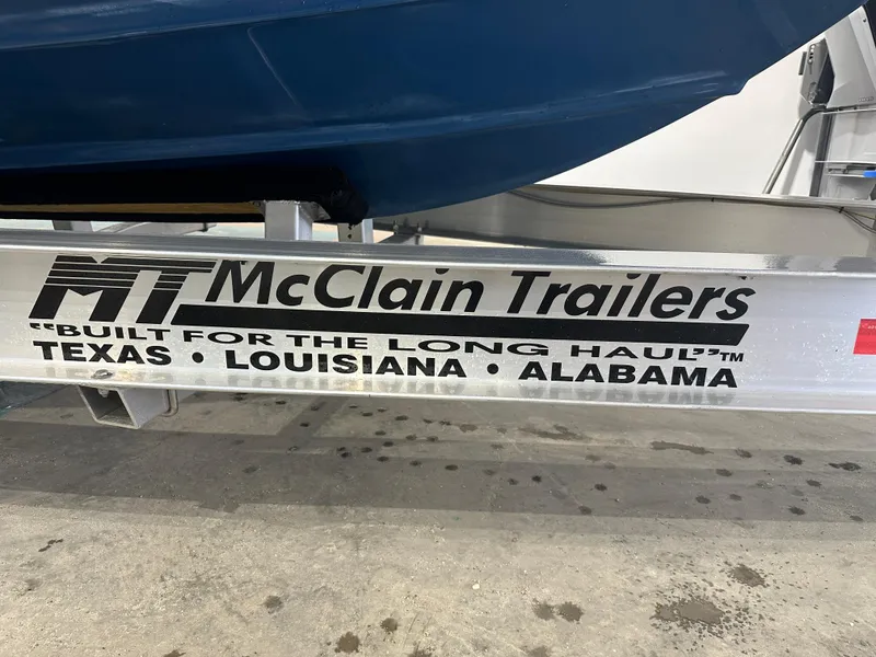 Slide: The Image of McClain Trailers with Tidewater 292CC boat, 2024 model, on display. - 19