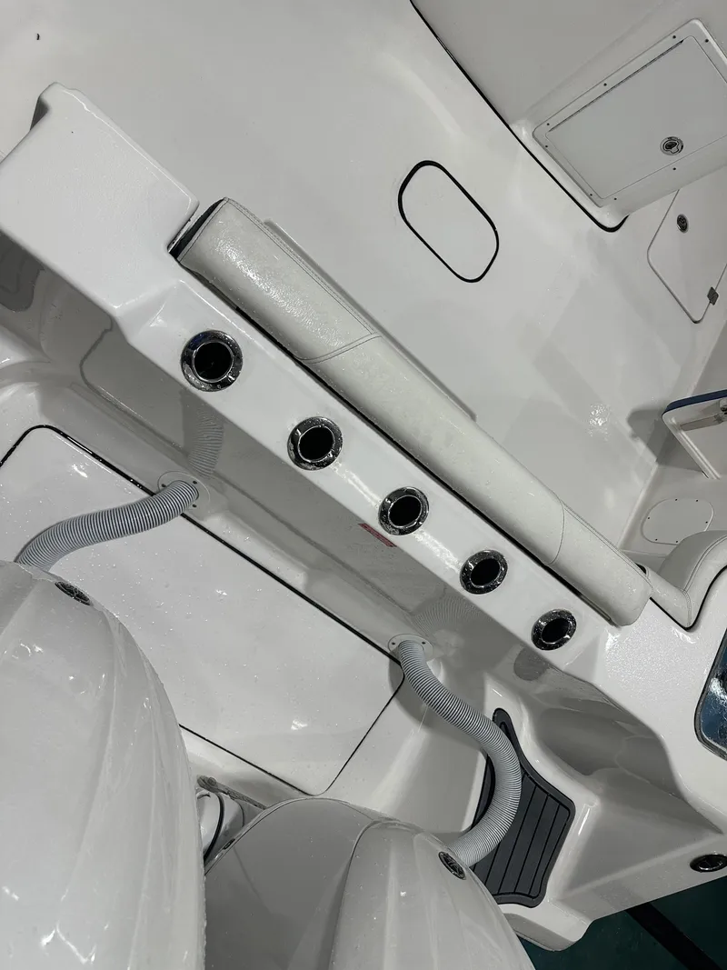 Slide: The Image of 2024 Tidewater 292CC boat interior with rod holders and engine connections. - 20