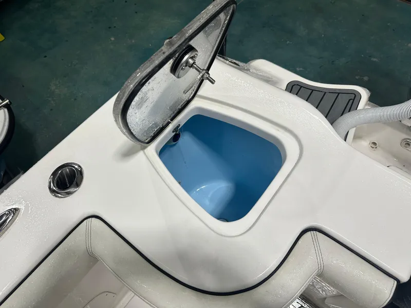 Slide: The Image of 2024 Tidewater 292CC boat livewell with open lid, showcasing interior design. - 21