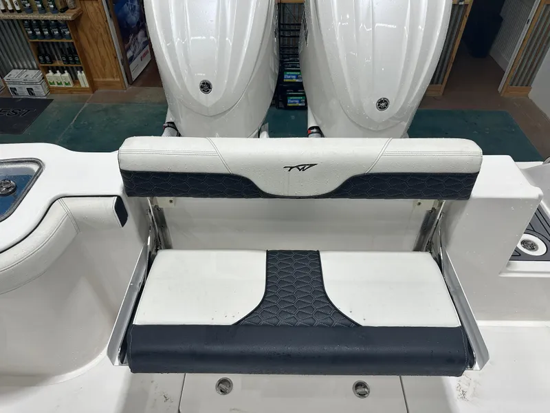 Slide: The Image of 2024 Tidewater 292CC boat seat with dual engines in a showroom. - 23