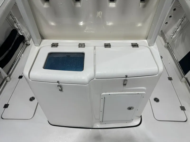 Slide: The Image of 2024 Tidewater 292CC boat interior with storage compartments and livewell. - 25