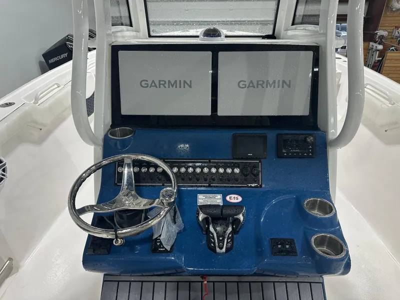 Slide: The Image of 2024 Tidewater 292CC boat dashboard with dual Garmin displays and Mercury controls. - 27