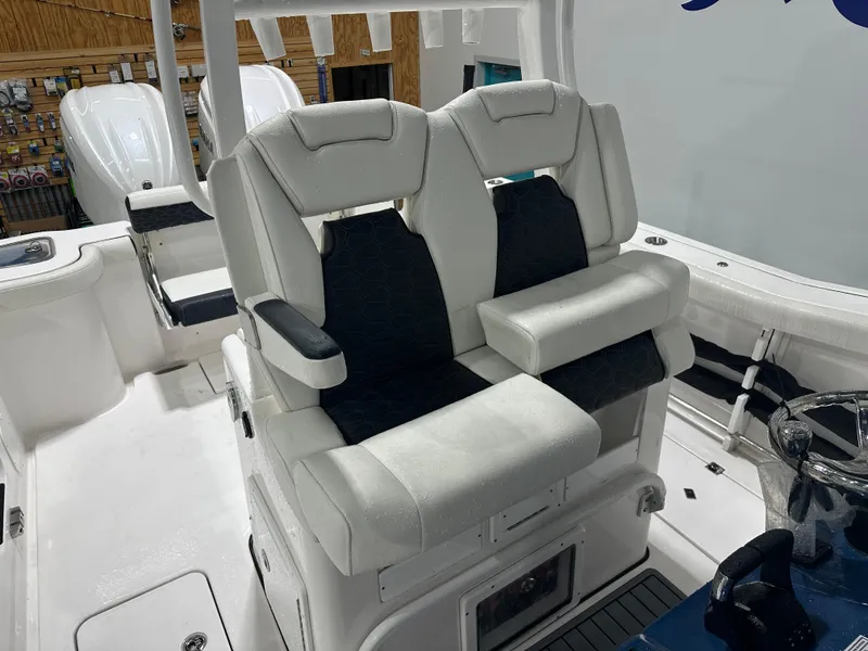 Slide: The Image of 2024 Tidewater 292CC boat with dual captain's chairs and sleek interior design. - 28