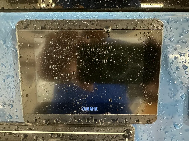 Slide: The Image of Yamaha display on 2024 Tidewater 292CC boat, covered in water droplets. - 31