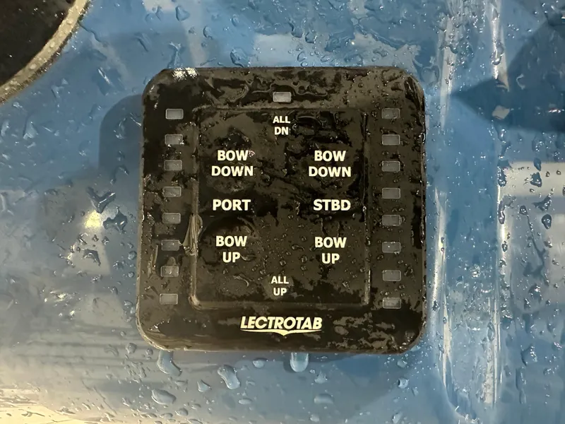 Slide: The Image of Control panel on a 2024 Tidewater 292CC boat, featuring trim tab adjustments. - 35