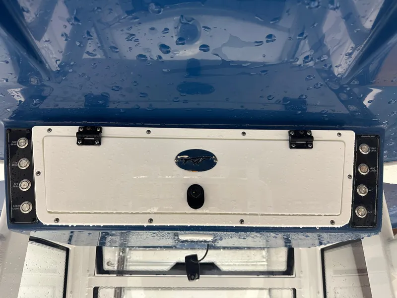 Slide: The Image of 2024 Tidewater 292CC boat console with control panel and switches, wet from rain. - 39
