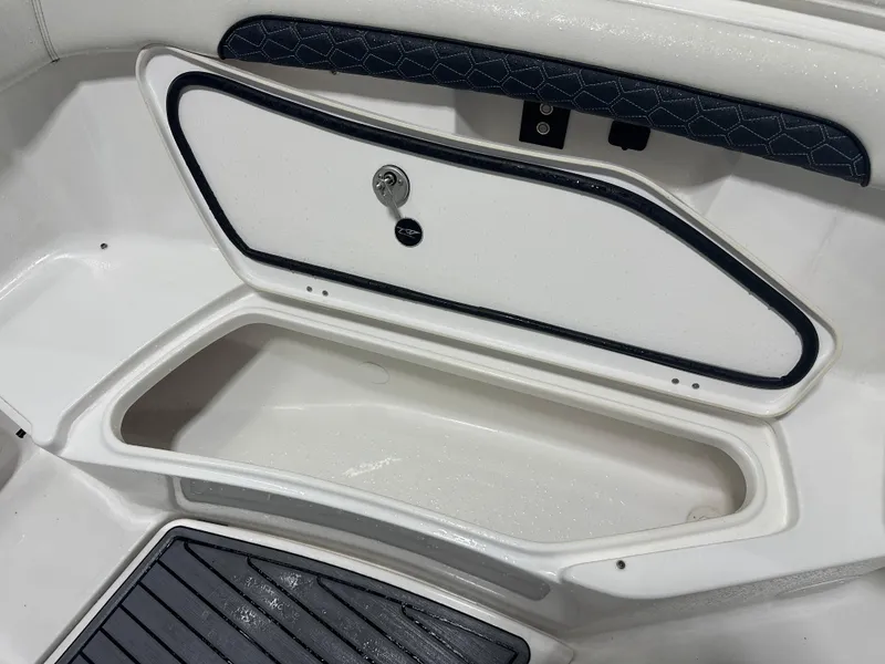 Slide: The Image of 2024 Tidewater 292CC boat storage compartment with open hatch and sleek design. - 46