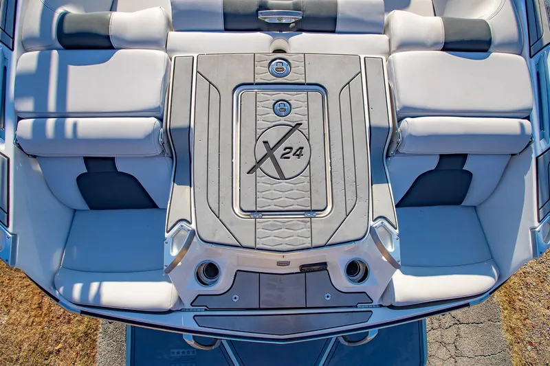 Slide: The Image of 2019 MasterCraft X24 boat interior with cushioned seating and sleek design. - 14