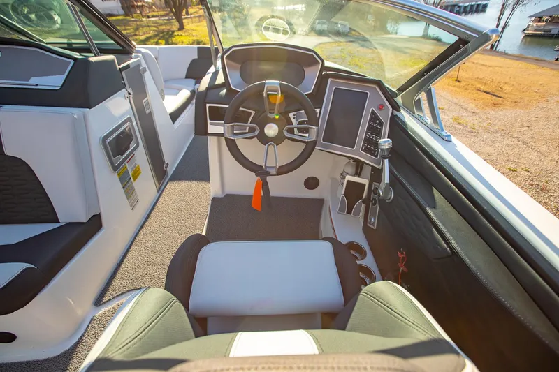 Slide: The Image of 2019 MasterCraft X24 boat interior with modern dashboard and steering wheel. - 19
