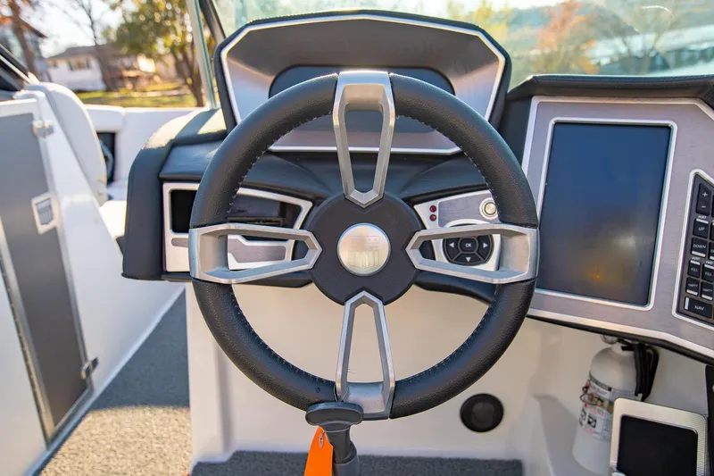 Slide: The Image of Steering wheel of a 2019 MasterCraft X24 boat with modern dashboard controls. - 20