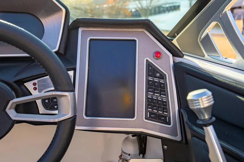 Slide: The Image of 2019 MasterCraft X24 boat dashboard with touchscreen and control panel. - 21