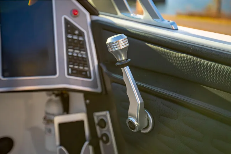 Slide: The Image of 2019 MasterCraft X24 boat interior with control lever and dashboard. - 22