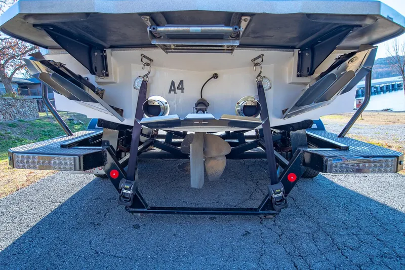 Slide: The Image of Rear view of 2019 MasterCraft X24 boat showing propeller and trim tabs. - 41