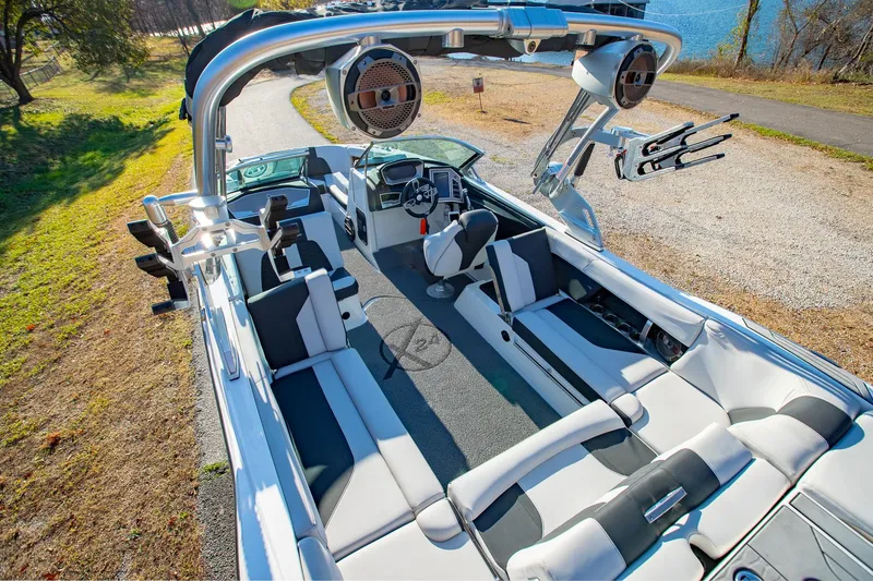 Slide: The Image of 2019 MasterCraft X24 boat interior with sleek seating and advanced audio system. - 6
