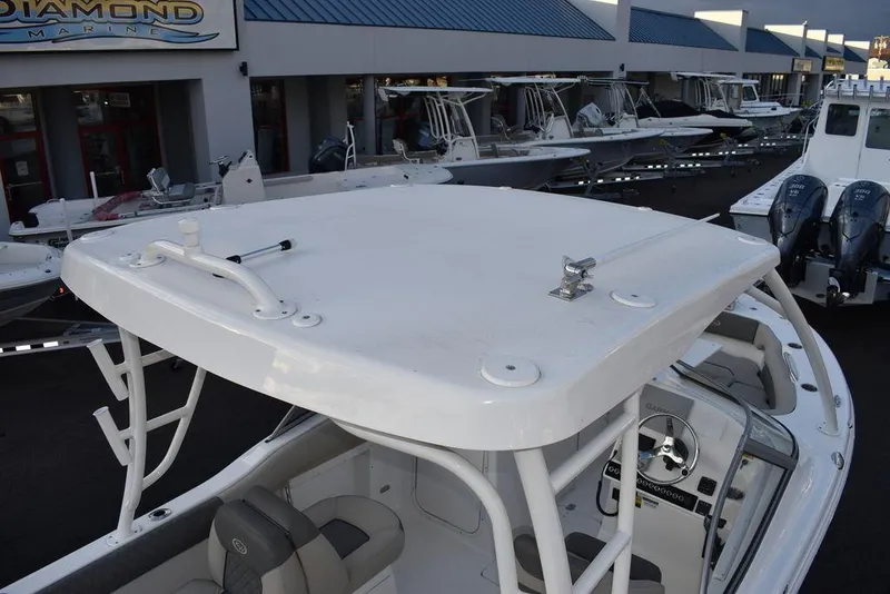 Slide: The Image of 2025 Key West 239 DFS boat with T-top, displayed at a marina. - 11