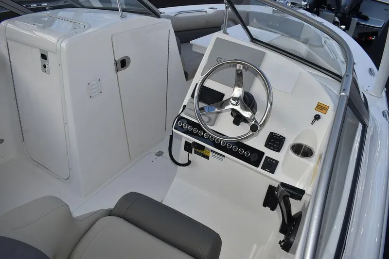 Slide: The Image of 2025 Key West 239 DFS boat cockpit with steering wheel and controls. - 14