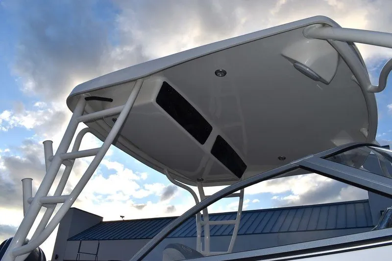 Slide: The Image of 2025 Key West 239 DFS boat with sleek T-top against a cloudy sky. - 23