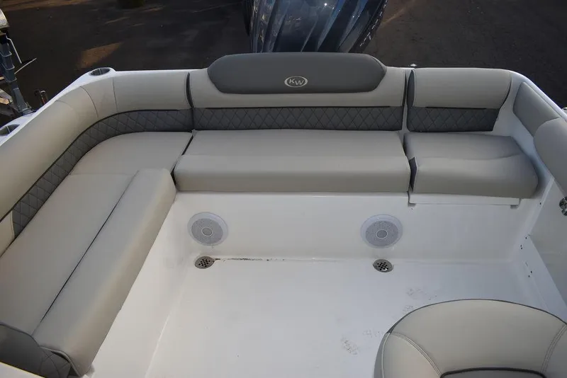 Slide: The Image of 2025 Key West 239 DFS boat interior with cushioned seating and speakers. - 27