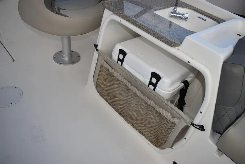 Slide: The Image of 2025 Key West 239 DFS boat interior with storage compartment and cooler. - 31