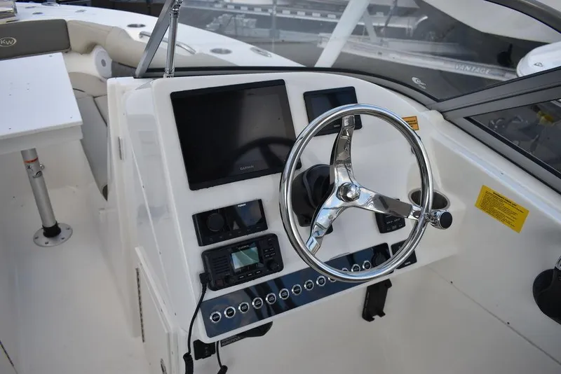 Slide: The Image of 2025 Key West 239 DFS boat dashboard with steering wheel and electronic displays. - 38