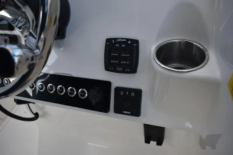 Slide: The Image of 2025 Key West 239 DFS boat dashboard with controls and cup holder. - 40