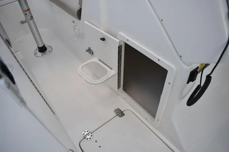 Slide: The Image of 2025 Key West 239 DFS boat interior, featuring storage compartment and clean white finish. - 43