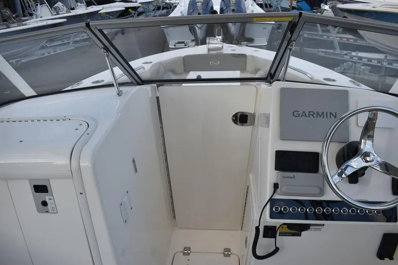 Slide: The Image of 2025 Key West 239 DFS boat cockpit with Garmin navigation system and steering wheel. - 44