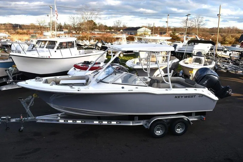 Slide: The Image of 2025 Key West 239 DFS boat on trailer in marina setting. - 5