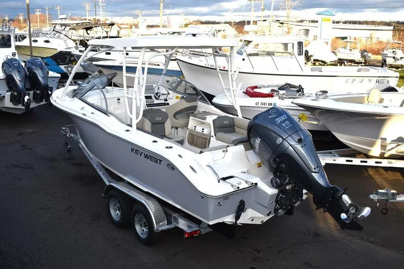 Slide: The Image of 2025 Key West 239 DFS boat with Yamaha engine on trailer in marina. - 6